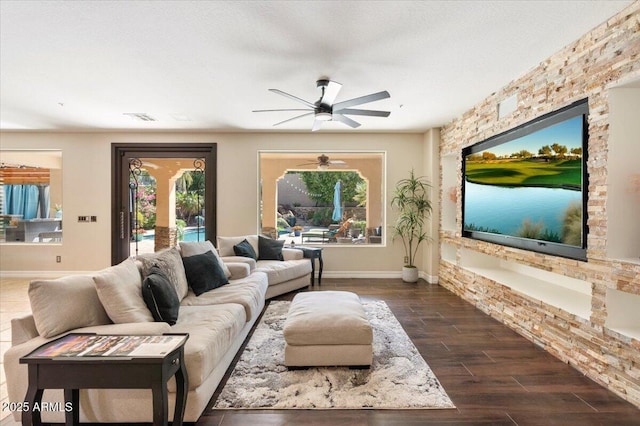 living room with ceiling fan and dark hardwood / wood-style flooring