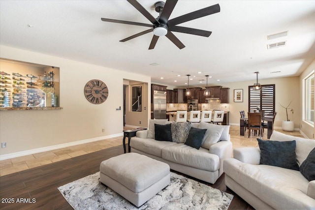 living room with ceiling fan and dark hardwood / wood-style flooring