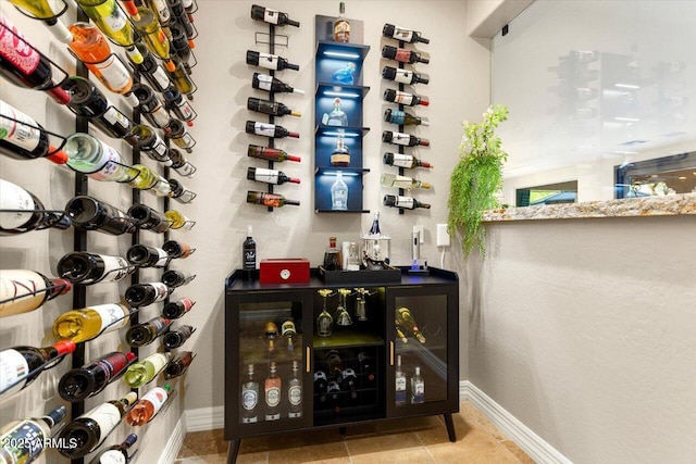 wine cellar featuring baseboards and tile patterned floors