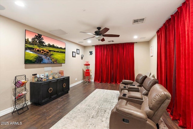 cinema with ceiling fan, dark wood-type flooring, visible vents, and baseboards