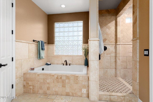 bathroom featuring a tile shower and a bath