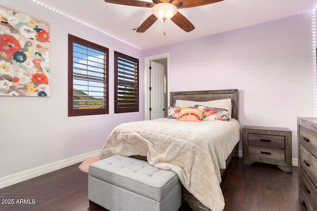 bedroom featuring ceiling fan, dark wood-style flooring, and baseboards