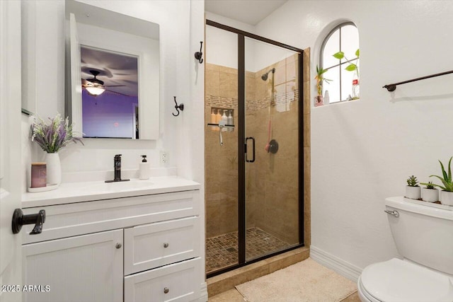 full bathroom featuring baseboards, a shower stall, toilet, and vanity