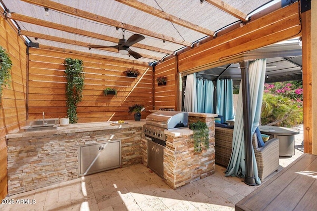 view of patio featuring area for grilling, a grill, and a ceiling fan