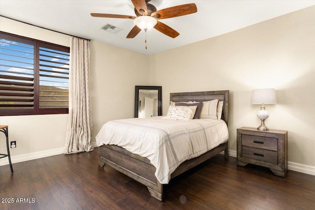 bedroom with a ceiling fan, baseboards, visible vents, and wood finished floors