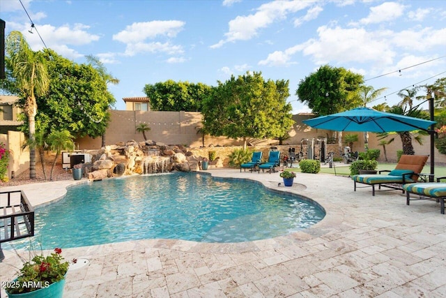 view of swimming pool featuring pool water feature and a patio area