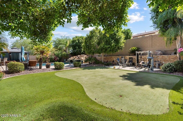 view of yard with a fenced in pool, a fenced backyard, and a patio