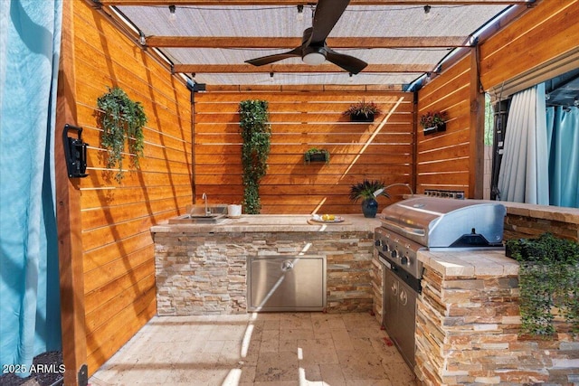 view of patio with a grill, an outdoor kitchen, and ceiling fan