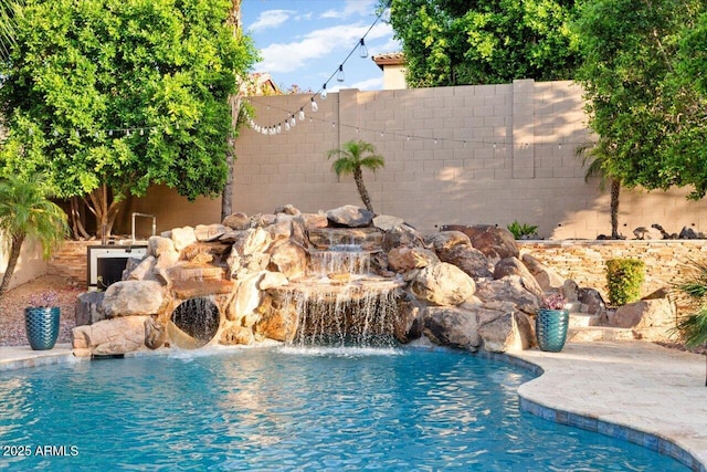 view of pool with a fenced backyard