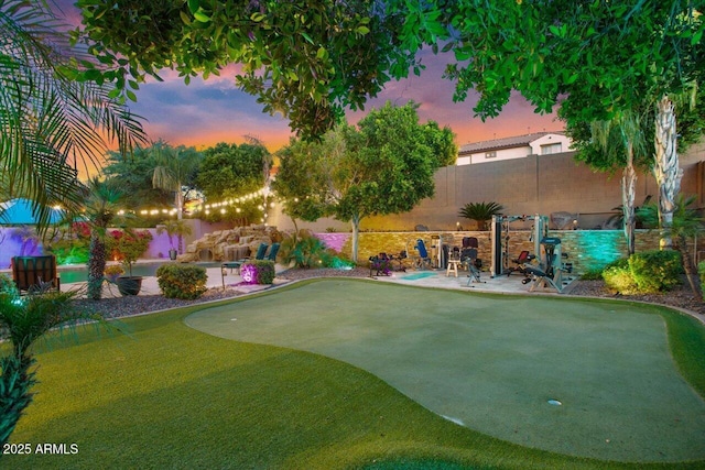 view of community with a patio area and a fenced backyard