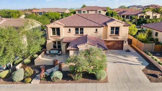 view of front of house featuring a residential view, driveway, a tiled roof, and stucco siding