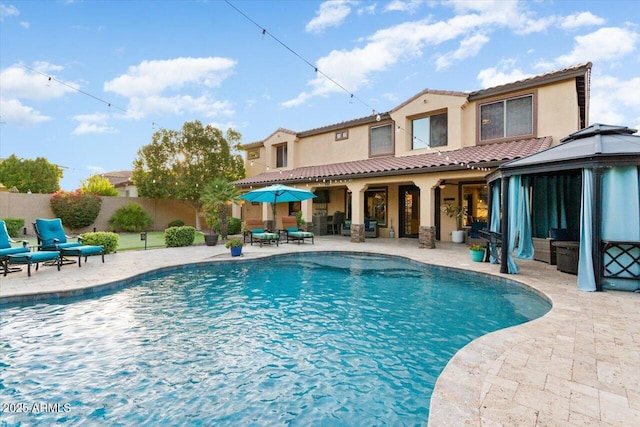 view of swimming pool with a patio area, fence, and a fenced in pool