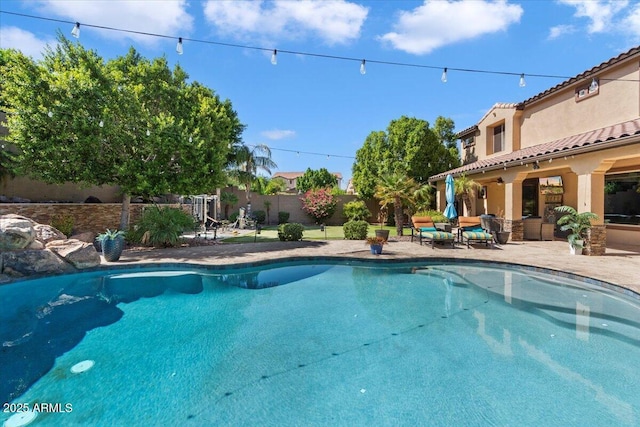 view of pool featuring a patio, a fenced backyard, and a fenced in pool