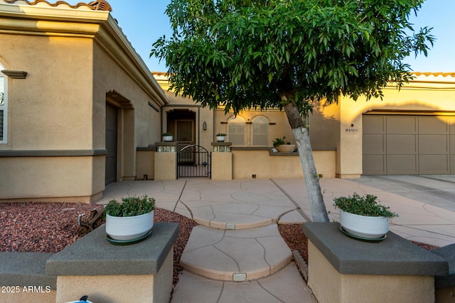 view of patio featuring driveway and a gate