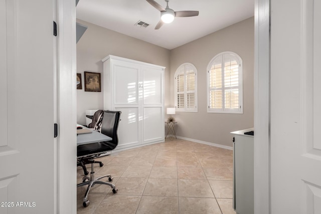 office featuring ceiling fan, visible vents, and light tile patterned floors