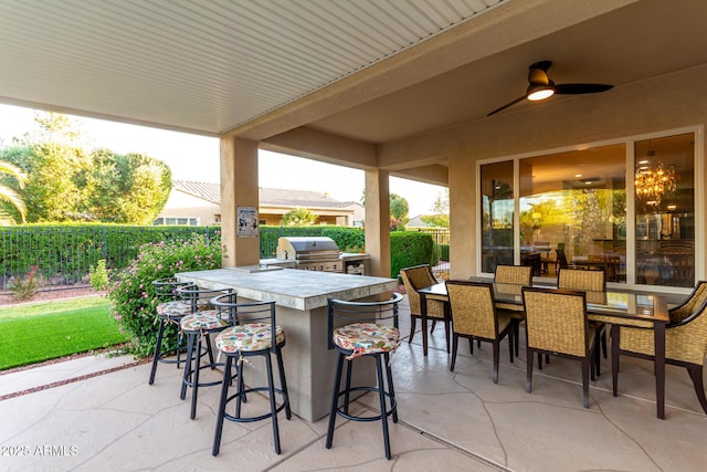 view of patio / terrace featuring fence, exterior kitchen, outdoor wet bar, and a grill