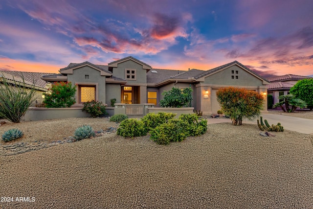 19562 N Wikieup Ct, Surprise, AZ 85374 - mediterranean / spanish-style home featuring concrete driveway, an attached garage, stucco siding, and a tiled roof
