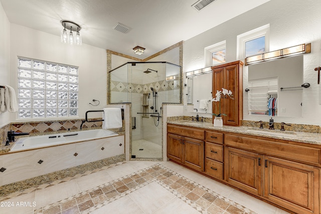 bathroom featuring vanity, shower with separate bathtub, and tile patterned flooring