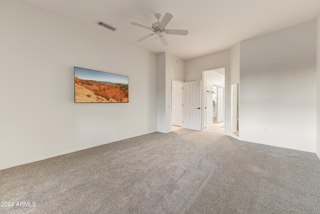 carpeted spare room featuring ceiling fan