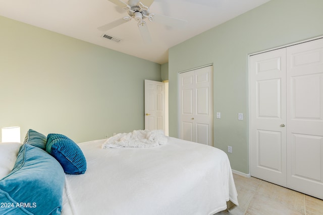 bedroom with two closets and ceiling fan