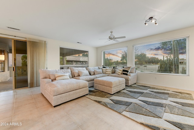 living room with ceiling fan and a healthy amount of sunlight