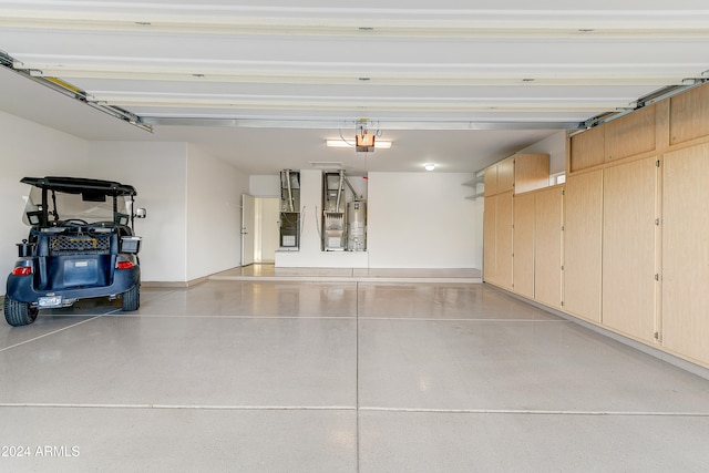 garage with a garage door opener and water heater