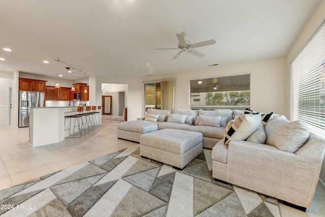 living room with light tile patterned floors and ceiling fan