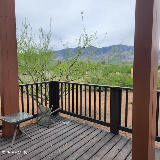 wooden deck featuring a mountain view