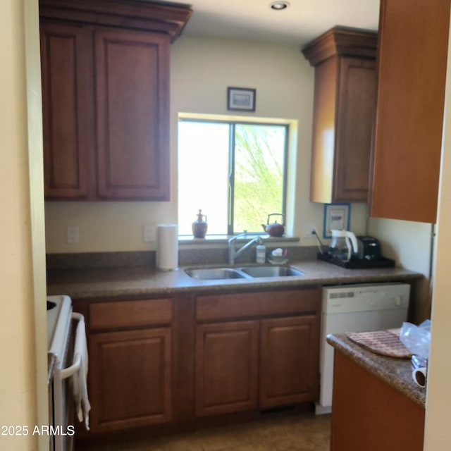 kitchen featuring stove, a sink, white dishwasher, brown cabinets, and recessed lighting