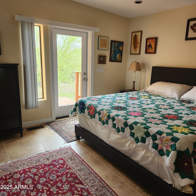 bedroom featuring access to outside, multiple windows, and tile patterned flooring