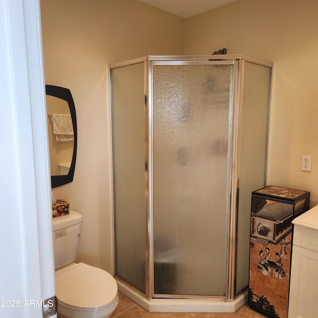 bathroom featuring a stall shower and toilet