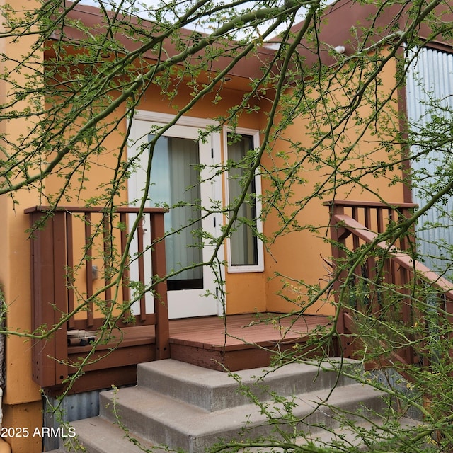 doorway to property with stucco siding