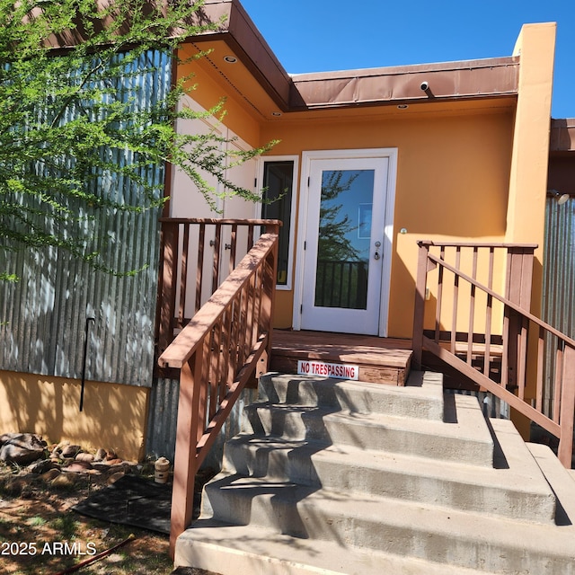property entrance with stucco siding