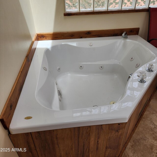full bath with a tub with jets