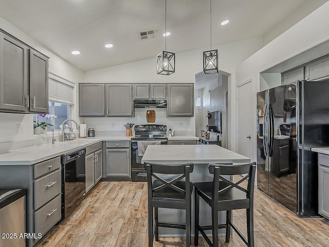 kitchen featuring a sink, light wood-style flooring, gray cabinetry, and black appliances