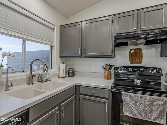 kitchen featuring under cabinet range hood, black / electric stove, a sink, light countertops, and gray cabinets