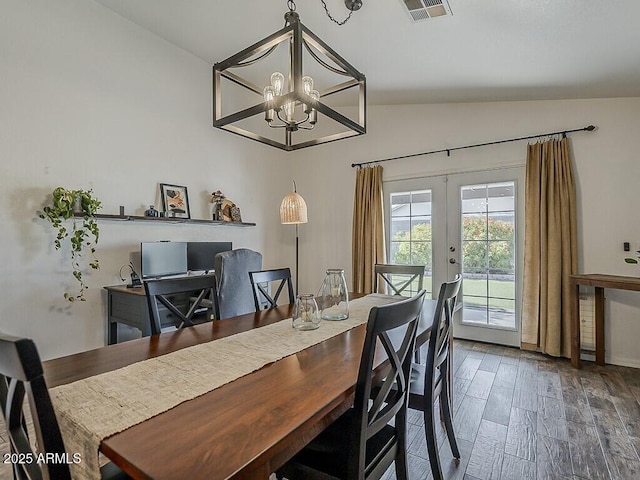 dining space with wood finished floors, french doors, a notable chandelier, visible vents, and vaulted ceiling