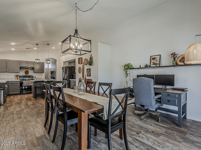 dining room featuring lofted ceiling, an inviting chandelier, recessed lighting, and dark wood-style floors