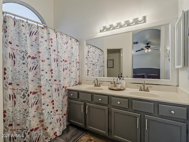 bathroom with a sink, double vanity, a ceiling fan, and visible vents