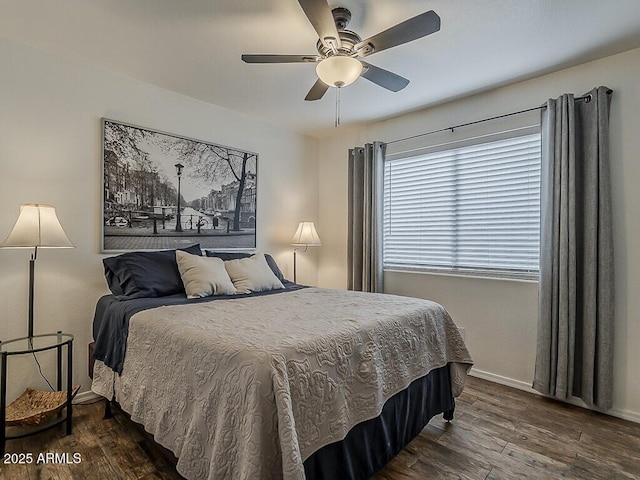 bedroom with baseboards, dark wood-style flooring, and a ceiling fan