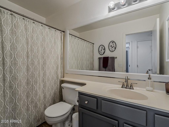 full bath featuring toilet and vanity