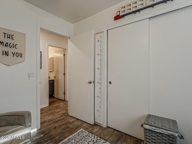 unfurnished bedroom featuring a closet and dark wood-type flooring