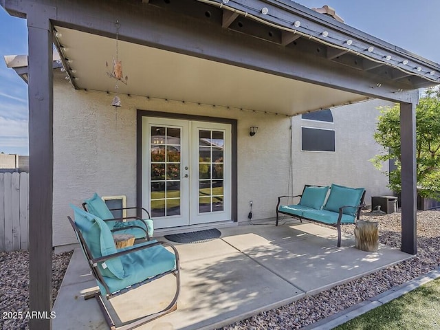 view of patio with fence, french doors, and central AC