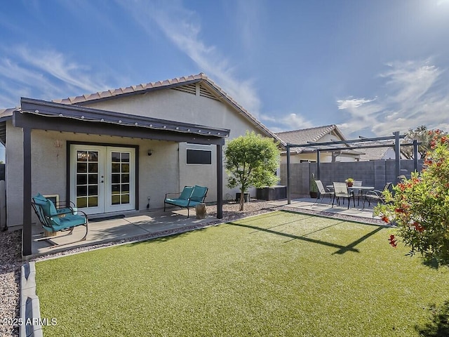 rear view of property with a patio area, stucco siding, french doors, and fence