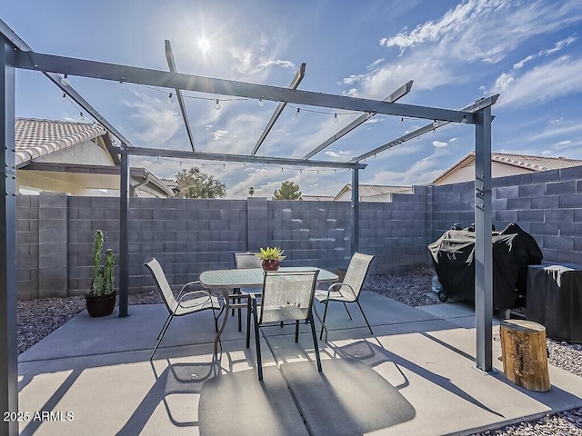 view of patio / terrace with a pergola, a fenced backyard, and outdoor dining space