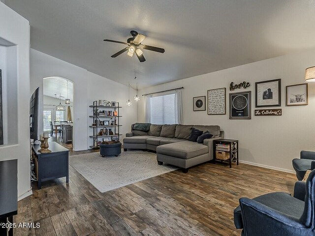 living room with arched walkways, ceiling fan, plenty of natural light, and wood finished floors