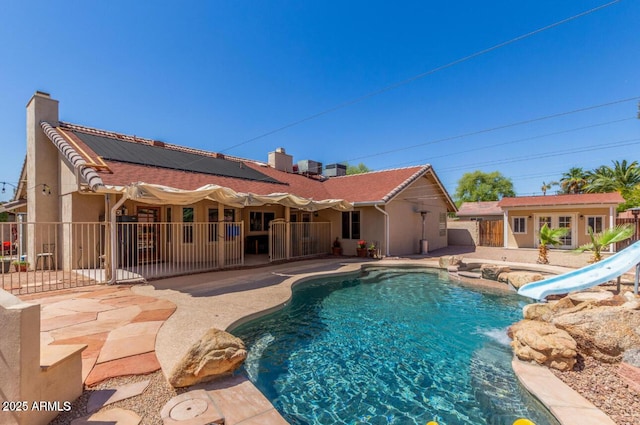 15825 N 45th St, Phoenix, AZ 85032 - view of swimming pool with a water slide, an outbuilding, a patio area, and an in-ground hot tub