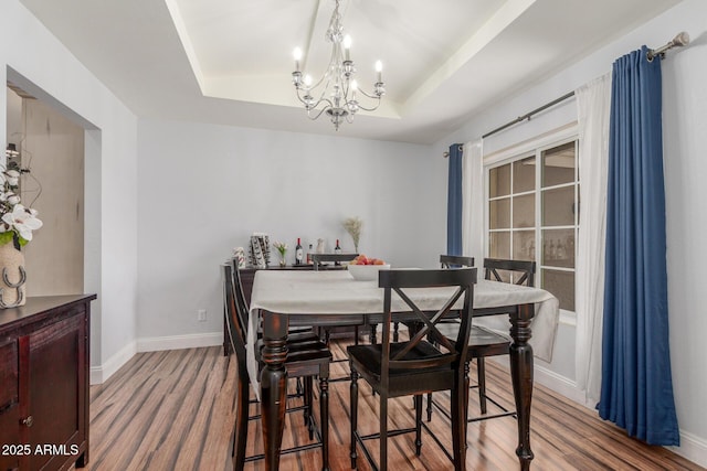 15825 N 45th St, Phoenix, AZ 85032 - dining room featuring a tray ceiling, a chandelier, wood finished floors, and baseboards