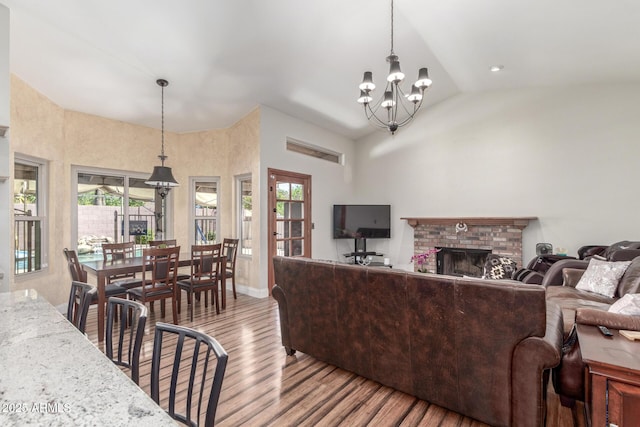 15825 N 45th St, Phoenix, AZ 85032 - living room featuring wood finished floors, a chandelier, high vaulted ceiling, a fireplace, and baseboards