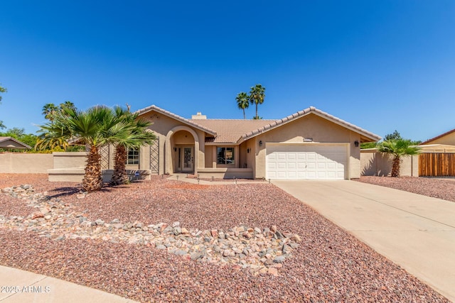15825 N 45th St, Phoenix, AZ 85032 - view of front of home featuring concrete driveway, stucco siding, an attached garage, a tiled roof, and a chimney